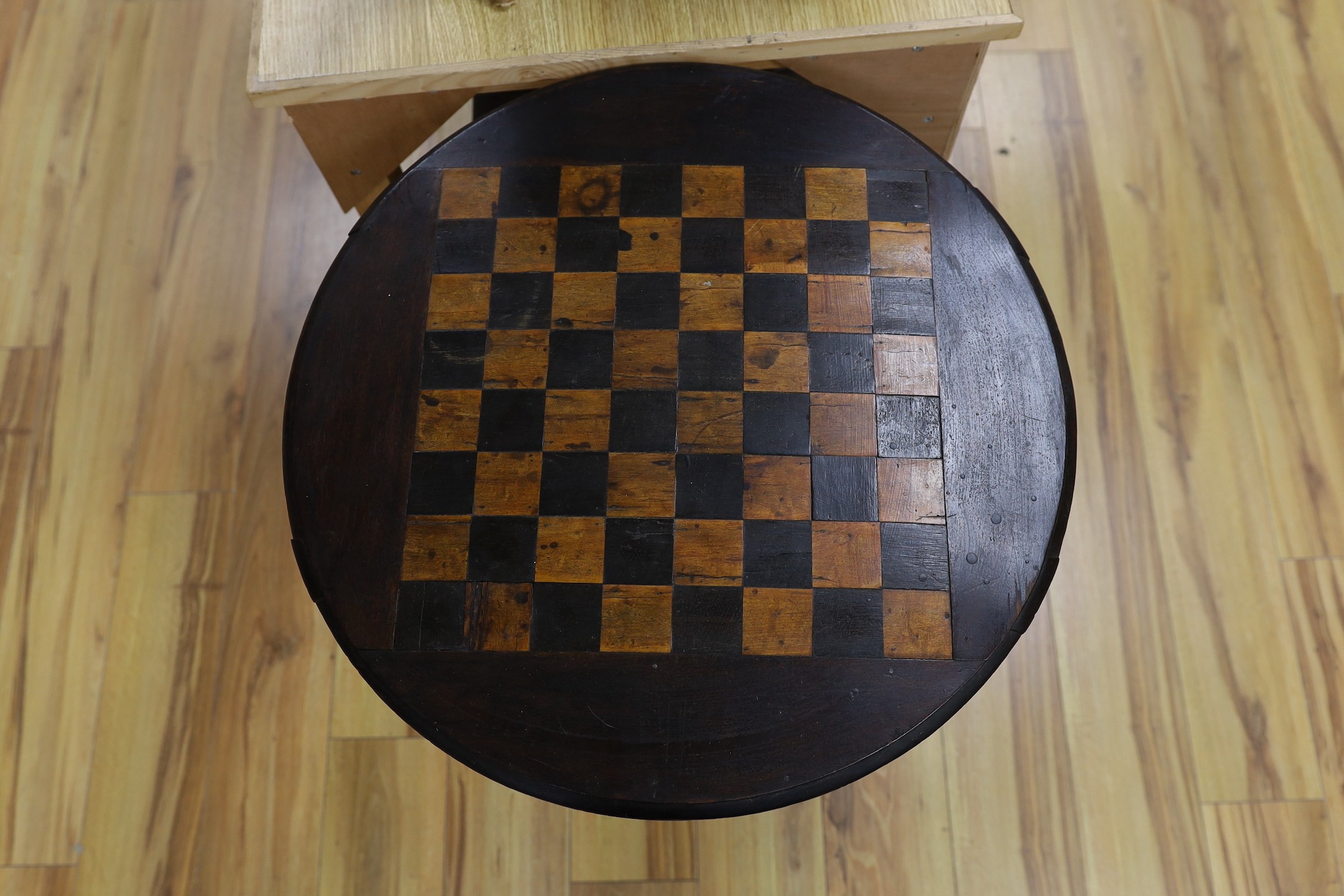 A stained pine inlaid chessboard top table, 75cm high, 56cm diameter and a set of Staunton chess pieces